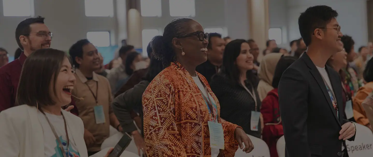 Dr. Égo Obi laughing with fellow attendees at an event